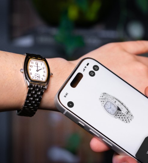 A phone tapped against a chipped watch to verify it